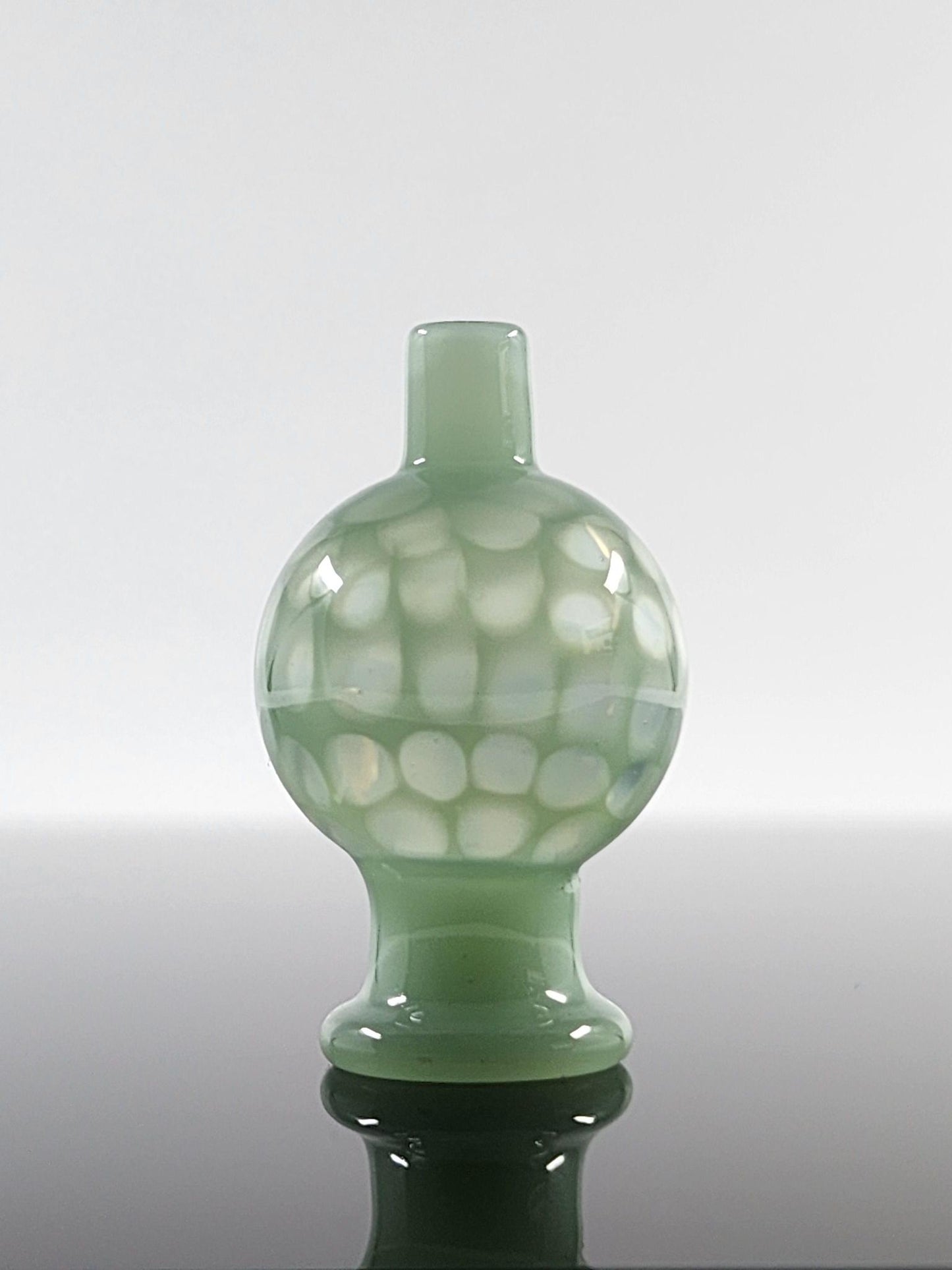 BSG Full Color Honeycomb Bubble Cap in hand, demonstrating its ergonomic design and comfortable grip for efficient airflow control during dabbing sessions.