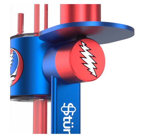 Side angle of the Grateful Dead x Stündenglass Gravity Infuser showcasing its 360° rotating design and anodized aluminum build.