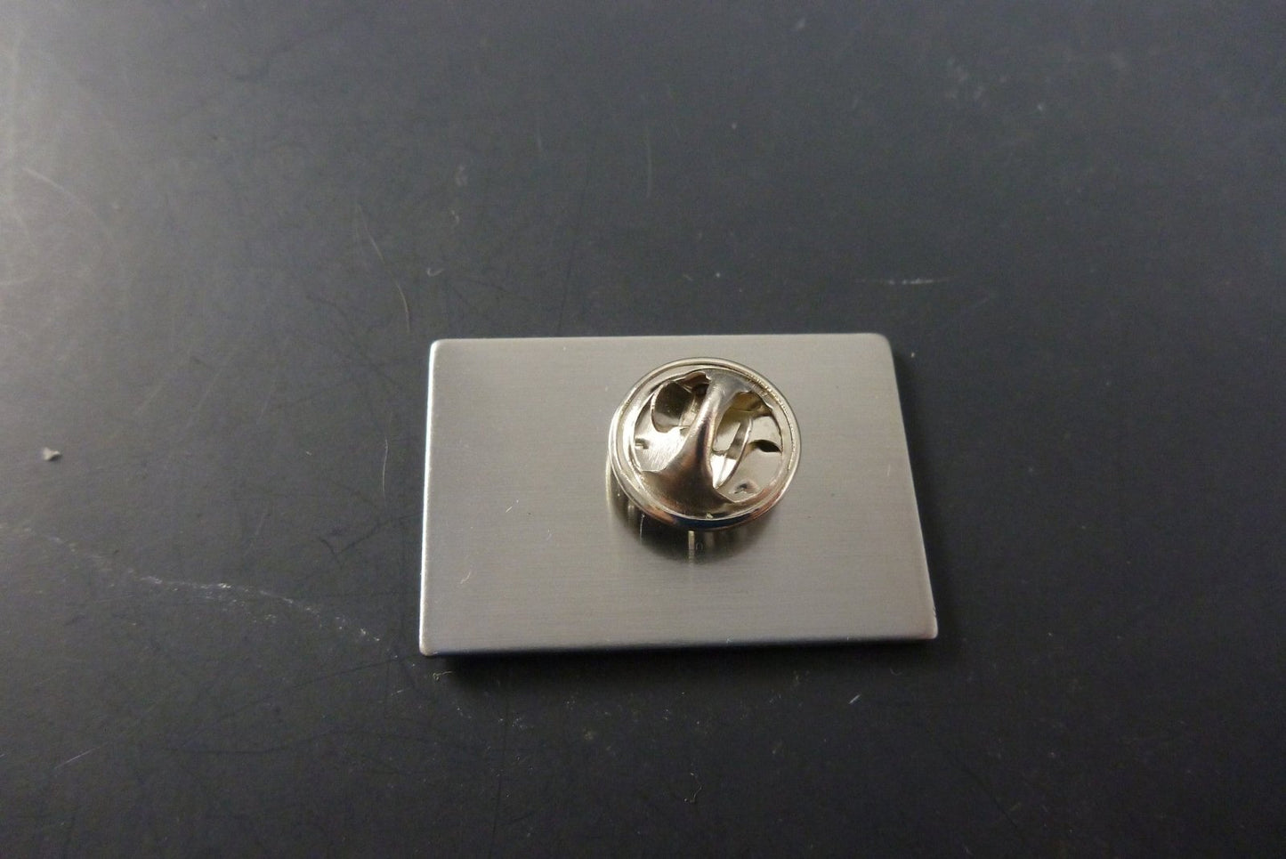 Close-up of the GRC Bear Pin, showcasing its iconic bear design and high-quality enamel, ideal for collectors who appreciate timeless style.