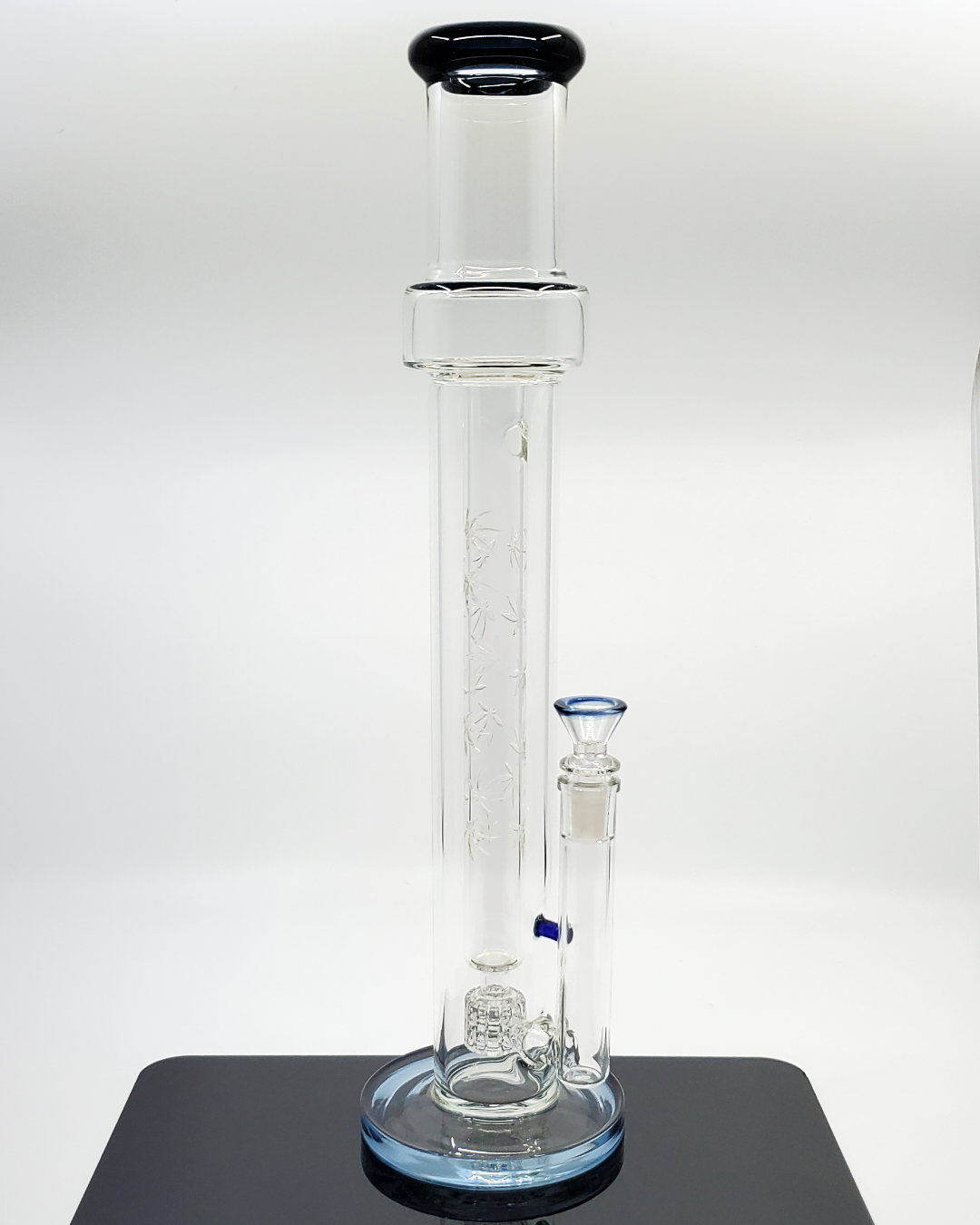 Side view of the DHK Glass 17” Pot Leaf Straight Tube showcasing its decorative pot leaf design and functional filtration for an enhanced smoking experience.