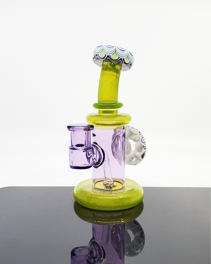 RL Dots Dotstack Jammer with Mouth Cab, a 14mm artistic dab rig featuring an intricate dotstack pattern and a cabbed mouthpiece, combining functionality with a modern aesthetic, suited for art enthusiasts and collectors alike.