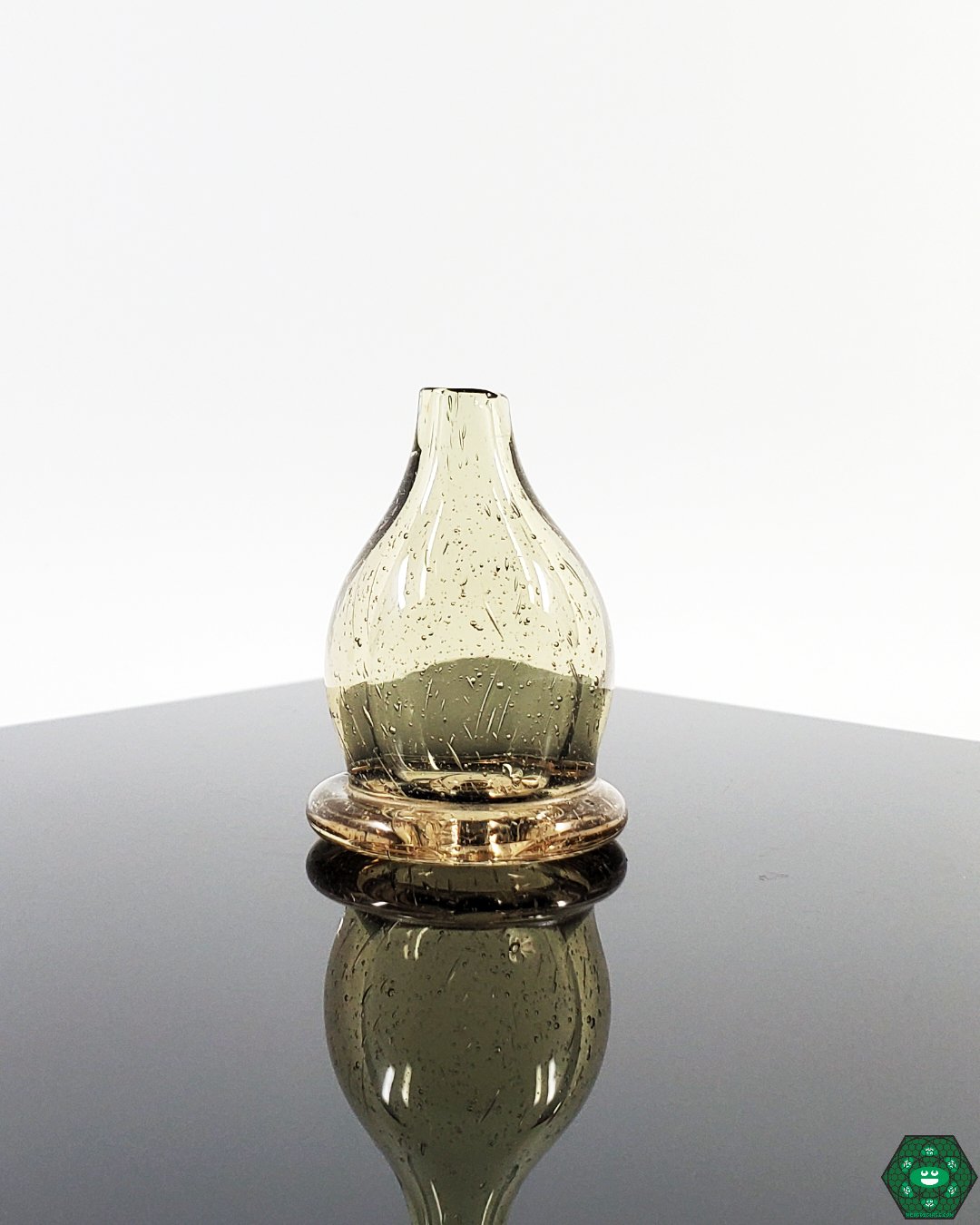 Glass Bubble Cap - Bigfoot. Available in Pomegranate, Plasma, Blue Stardust, and Tan. Fits 25MM quartz nails, designed to optimize airflow and vapor quality.