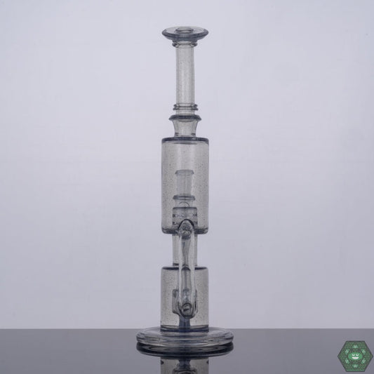 CFL Reactive Glass Rig: The Parallax Bubble Dumper by The Glass Carpenter changes color under CFL light, adding a unique dimension to your dabbing experience.