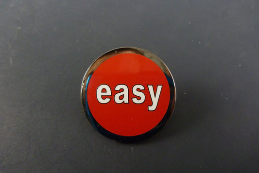 Fun “Easy Button” Style Pin, a lightweight and durable accessory that adds a playful touch to bags, hats, and casual wear.


