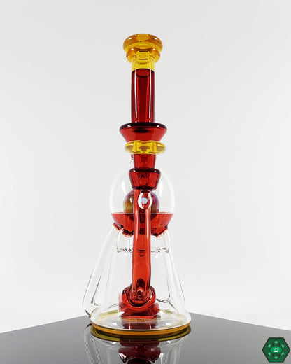 Innovative Glass Recycler: The OM Glass Co Vasuki, showcasing a unique design with triple uptake and a 3-hole perc, delivering exceptional function and smooth, filtered hits for discerning enthusiasts.