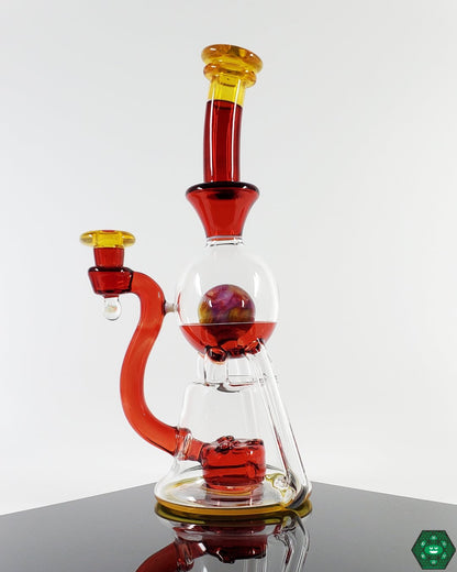 OM Glass Co Vasuki Recycler, an innovative design featuring triple uptake and a 3-hole perc for exceptional function, creating smooth and filtered hits, perfect for those who appreciate efficient, detailed craftsmanship.